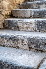 rough stone steps leading upwards  in an ancient mediterranean building