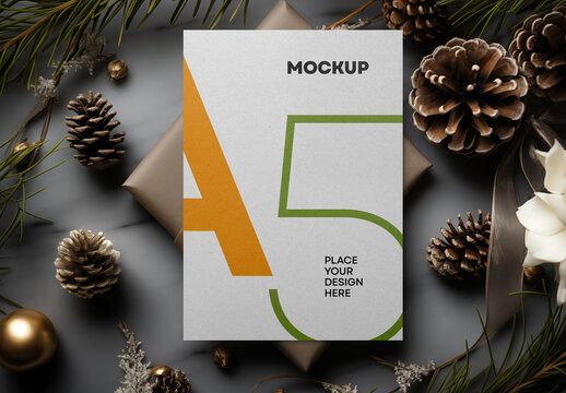 A5 Greeting Card Mockup &ndash; Elegant Holiday Scene with Pine Cones and Gift Box for Christmas or Seasonal Stationery Design Presentation