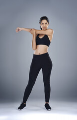 Obraz premium Woman, fitness and portrait with stretching, exercise and athlete for sports, training and workout. Female person, warm up and competition for health, performance and endurance on studio background