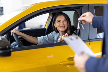 Salesman, woman and purchase a new car at dealership with test drive, happy and insight of vehicle details. Auto deal, customer and employee with professional service for transport safety and hiring