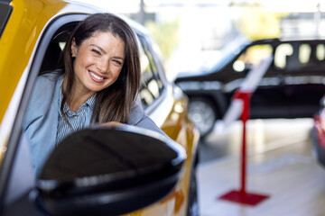 Buying New Car. Happy Young Woman Testing Automobile Sitting In Auto In Dealership Center.