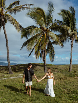 Couple holding hands walking looking at eachother