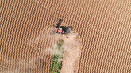 combine harvesting beans on edge of field