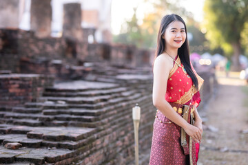 Portrait Beautiful asian woman in Thai traditional Thai dress costume in front of Pagoda temple at the ancient city Thailand,Loy Krathong Festival,At the Thai temple fair at night