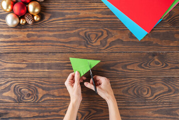 Step-by-step Christmas tree handmade paper toy. Step 10: Make cuts on both sides. Top view.