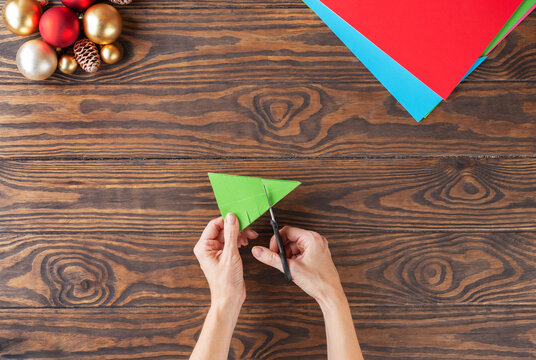 Step-by-step Christmas tree handmade paper toy. Step 10: Make cuts on both sides. Top view.