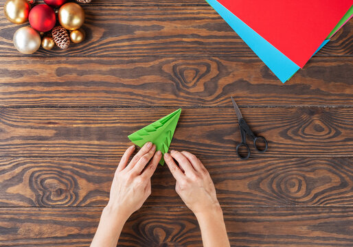 Step-by-step Christmas tree handmade paper toy. Step 11: Bend the corners of the tree. Top view.