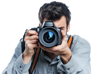 A male photographer in a casual outfit with a camera strap around his neck, holding a DSLR camera up to his eye as if taking a picture.