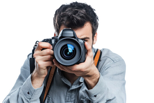 A male photographer in a casual outfit with a camera strap around his neck, holding a DSLR camera up to his eye as if taking a picture.