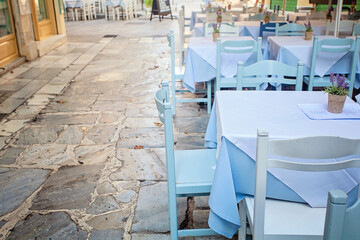 Blue table with white tablecloth outdoors. Athens, Greece