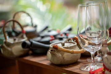 Teapots and glasses are arranged on display shelves.