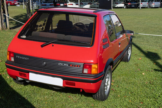 Red peugeot 205 gti parked on grass at car show