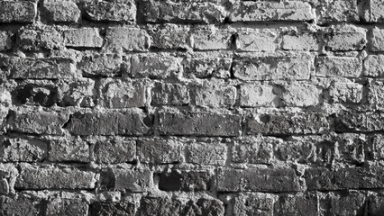 The photo shows an old gray brick wall