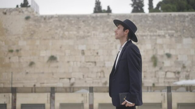 Orthodox Jewish Man Walking by the Western Wall, Jerusalem &ndash; Dolly Side Shot