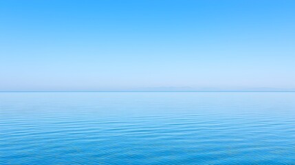 Obraz premium A serene and calming seascape photograph showcasing a tranquil ocean at dusk with distant islands silhouetted against the vibrant sunset sky on the horizon