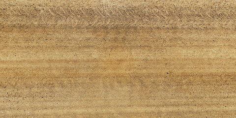 panorama view from above on texture of gravel sand road with car tire tracks
