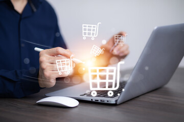 Businessman hold smartphone with online shopping concept, marketplace website with virtual interface of online Shopping cart part of the network, Online shopping business with selecting shopping cart.