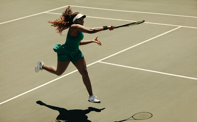 Powerful forehand hit by professional woman tennis player on court