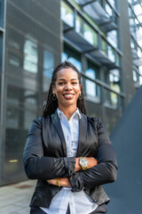 Fototapeta premium Proud latin businesswoman smiling with arms crossed in the city
