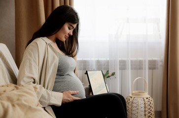 Midsection portrait of happy, beautiful, young careless pregnant woman, lady holding her baby bump,...