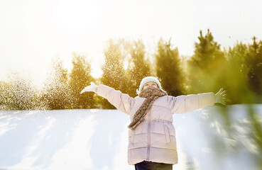 Happy beautiful child portrait. Excited kid playing in winter mountains forest. Funny little girl...