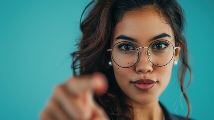 Fototapeta premium Portrait mockup of a female lawyer gesturing in a studio for advertising or marketing purposes. Mockup space for legal services or promotional offers against a blue backdrop