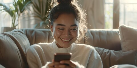 Person using a smartphone while sitting on a sofa, engaging with social media, updating apps, and communicating with contacts