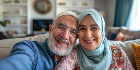 Selfie of a joyful senior couple in their living room celebrating Eid, showcasing culture and love, with a happy woman in hijab and a man, enjoying their time together for Ramadan