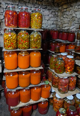 Large jars of pickled vegetables and jams in the cellar in Moldova 