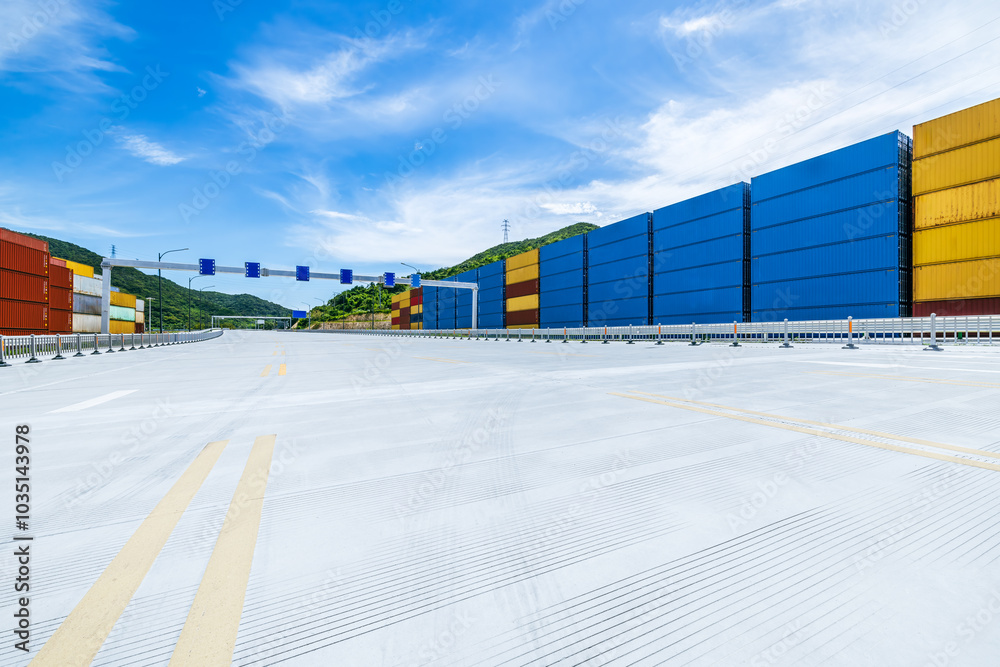 Aufkleber stacked containers and empty asphalt road at the port