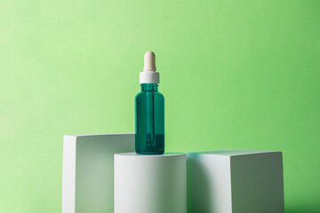 Blue sunscreen bottle on green background. Sunscreen concept. Skin care concept. Copy space.