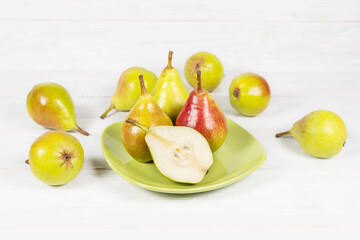 Pears and pear slice on white wooden background
