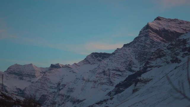 Snowy Himalayan mountain peaks during the sunset as seen from Sissu in Lahaul and Spiti district, Himachal Pradesh, India. Snowy mountains at Sissu village during the winter season. Travel background.