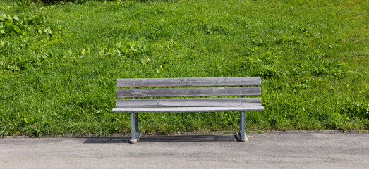 Wooden bench outside on the side of a Swiss road up a mountain pass.