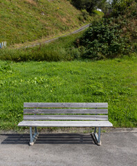 Wooden bench outside on the side of a Swiss road up a mountain pass.