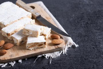 Christmas almond nougat on black slate background. Copy space