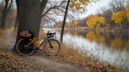 Fototapeta premium Bike by the River Amid Autumn Foliage