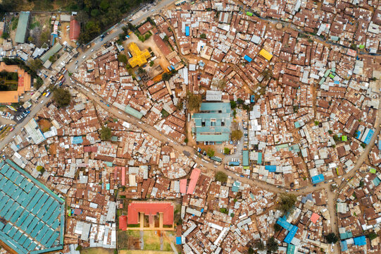 Aerial view of colorful rooftops and crowded buildings in Kibera slum, Nairobi, Kenya.