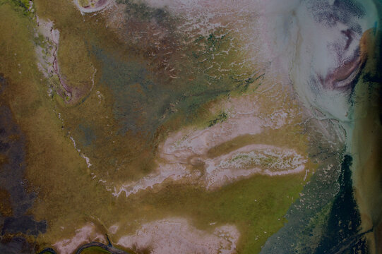 Aerial view of tidal abstract patterns in serene water landscape, Ullapool, United Kingdom.