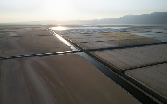 Aerial view of a beautiful salt farm with tranquil water reflections and serene fields, Dazkiri, Turkey.