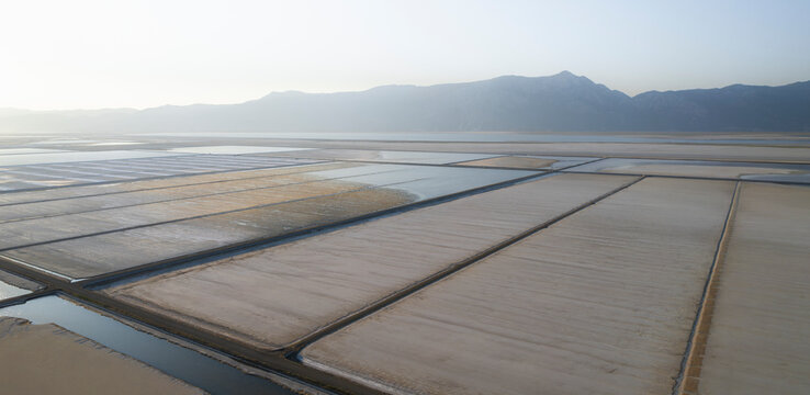 Aerial view of colorful salt farm and wetlands with textured patterns, Dazkiri, Turkey.