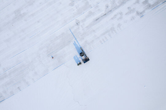 Aerial view of beautiful frozen salt farm with snow and ice patterns, Dazkiri, Turkey.