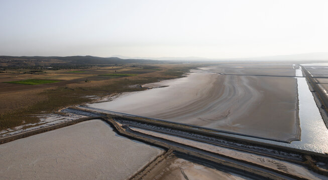 Aerial view of beautiful salt farm with serene patterns and reflections, Dazkiri, Turkey.