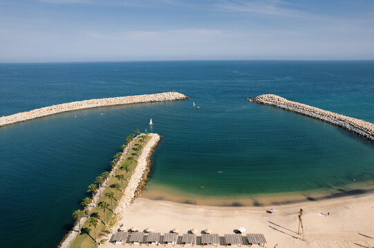 Aerial view of beautiful beach with palm trees and calm ocean, Beach Club, El Ganzo, Los Cabos, Mexico.