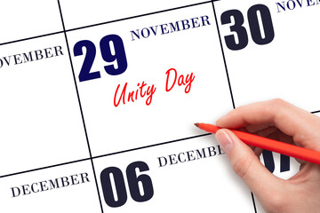 November 29. Hand writing text Unity Day on calendar date. Save the date.