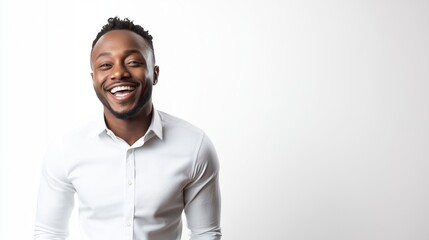 Fototapeta premium Portrait of a smiling man in a white shirt against a plain white background, expressing happiness and positivity with a bright and cheerful demeanor