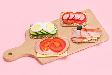 Different Whole Grain Crispbread with Ham, Tomato, Radish, Cucumber and Cheese. Easy Breakfast. Diet Food. Quick and Healthy Sandwiches. Crispbread with Tasty Filling. Healthy Dietary Snack