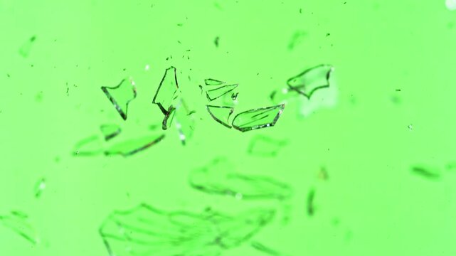 Super Slow Motion of Shattered Glass Isolated on Green Background. Filmed on High Speed Cinema Camera, 1000 fps.