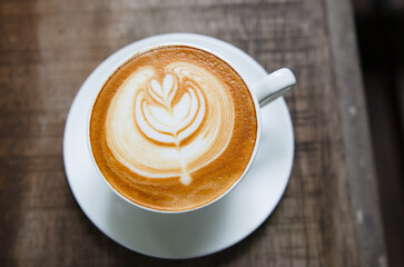 Latte Coffee on a Wooden Table A Warm Morning Moment