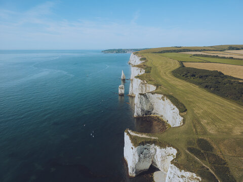 Aerial view of old harry rocks and rugged chalk cliffs along the coastline, Swanage, United Kingdom.